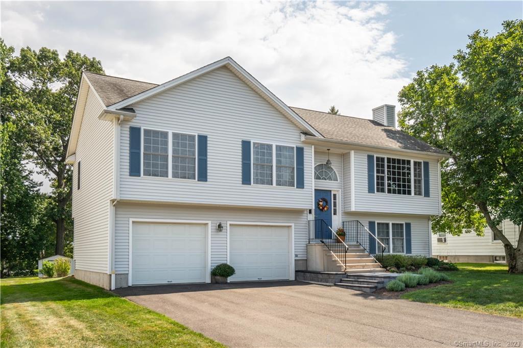 40 Colonial Heights Meriden, CT 06450 - Photo 1 of 1 a front view of a house with a yard and garage