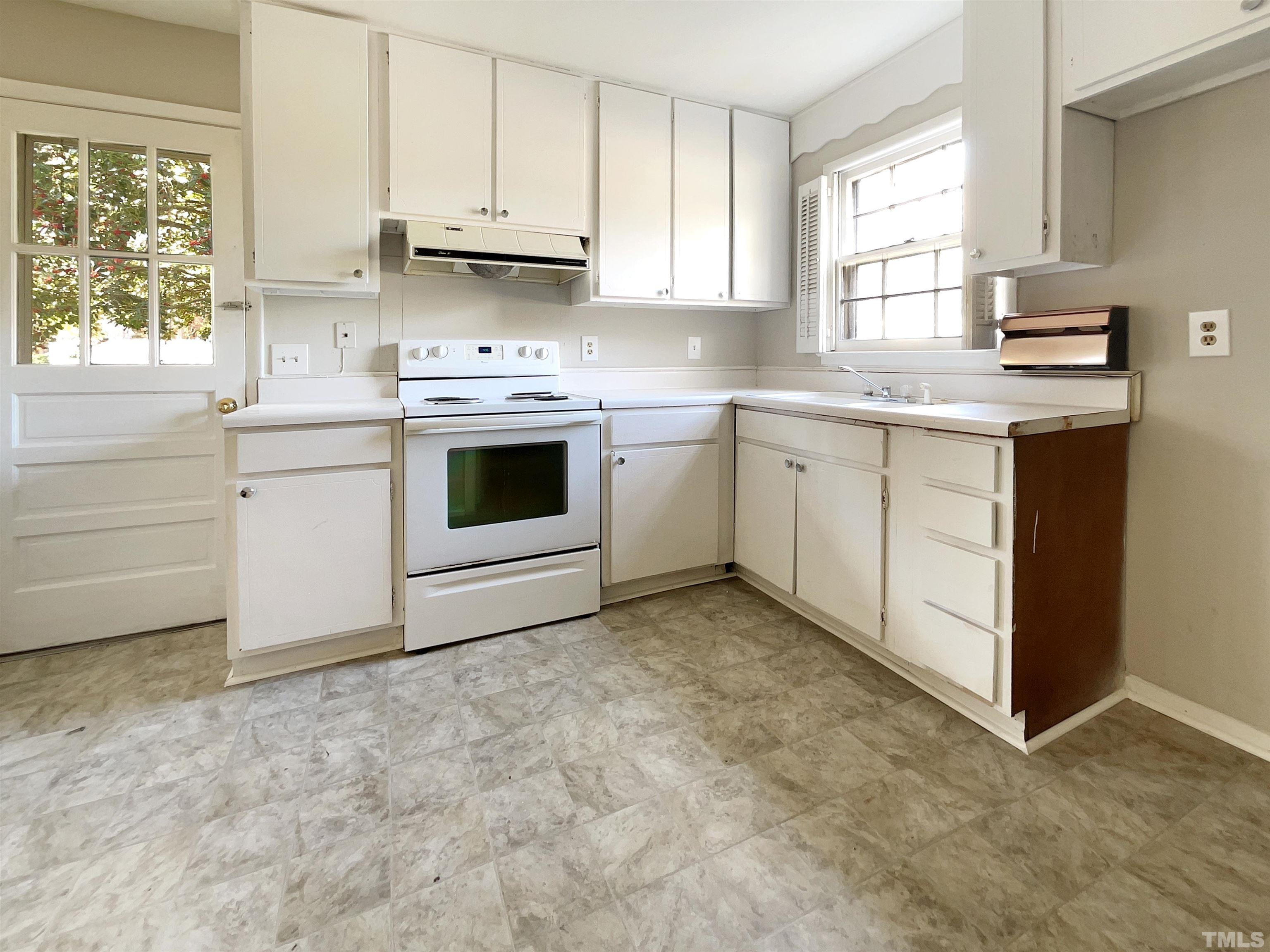2521 Little John Road Raleigh, NC 27610 - Photo 12 of 18 a kitchen with cabinets appliances a sink and a window