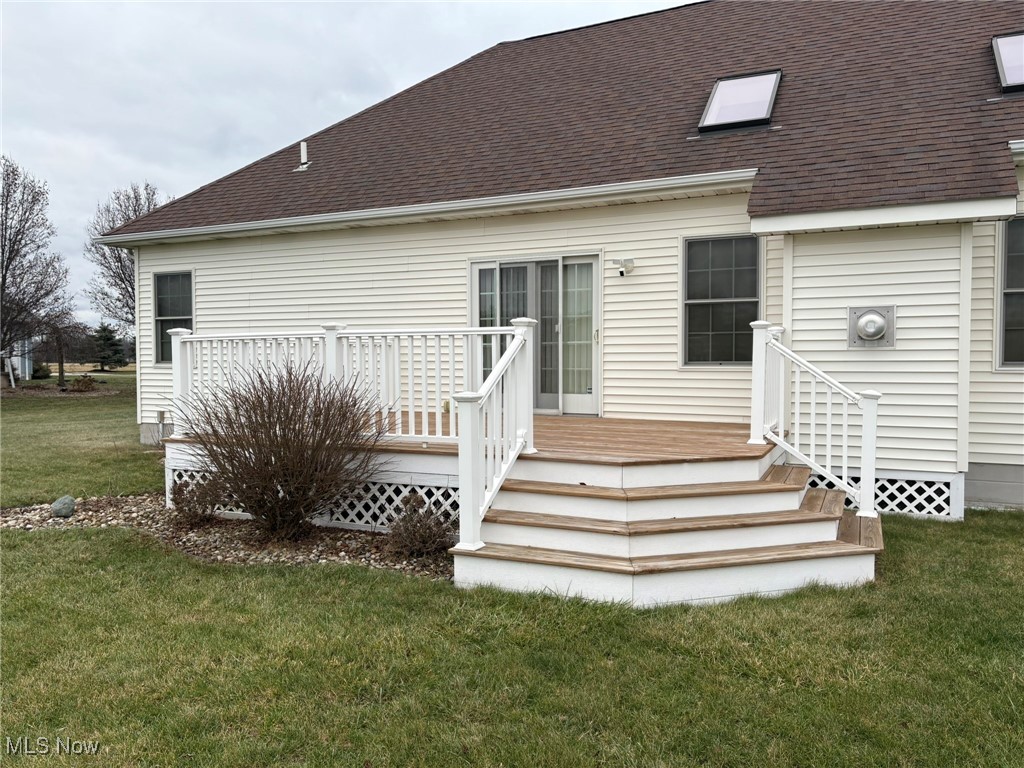 9260 Fowl Road Elyria, OH 44035 - Photo 19 of 25 Rear view of house featuring a lawn and a wooden deck