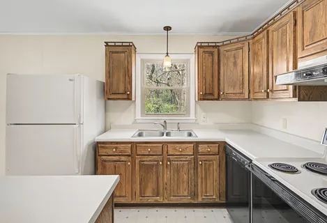 a kitchen with a stove a sink and a refrigerator
