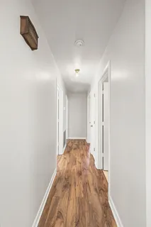 a view of hallway with wooden floor