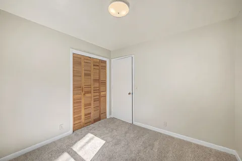 a view of an empty room and a window