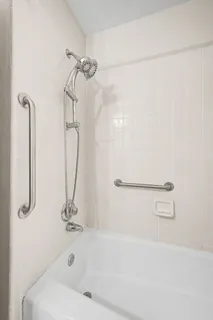 a bathroom with a bath tub with a shower