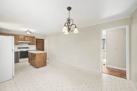 a kitchen with a refrigerator and cabinets