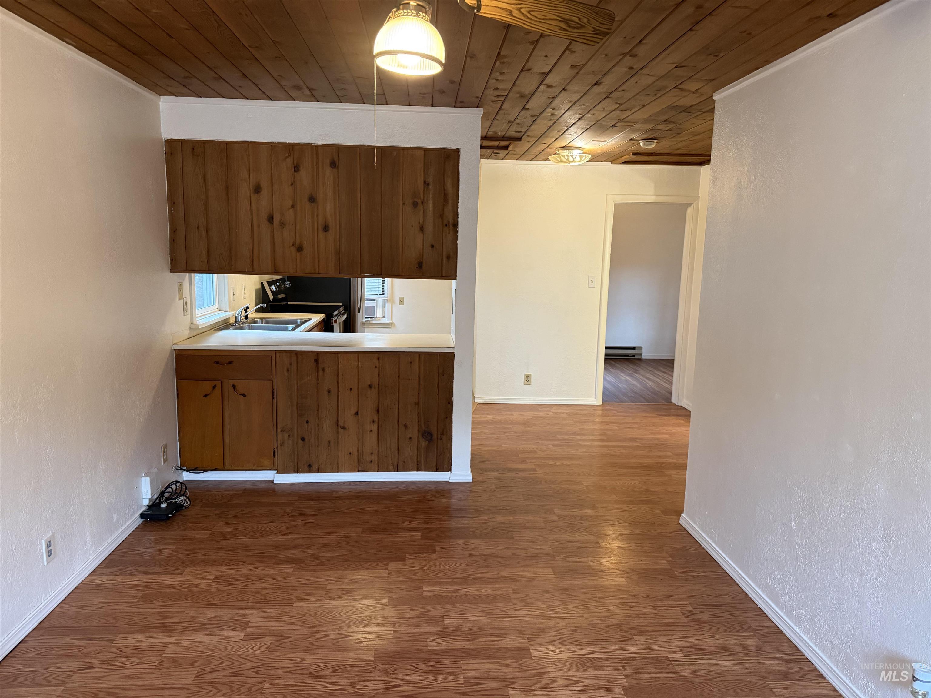 620 Riverside Avenue Orofino, ID 83544 - Photo 2 of 12 Kitchen with wood ceiling, dark wood finished floors, light countertops, brown cabinets, and stainless steel range oven