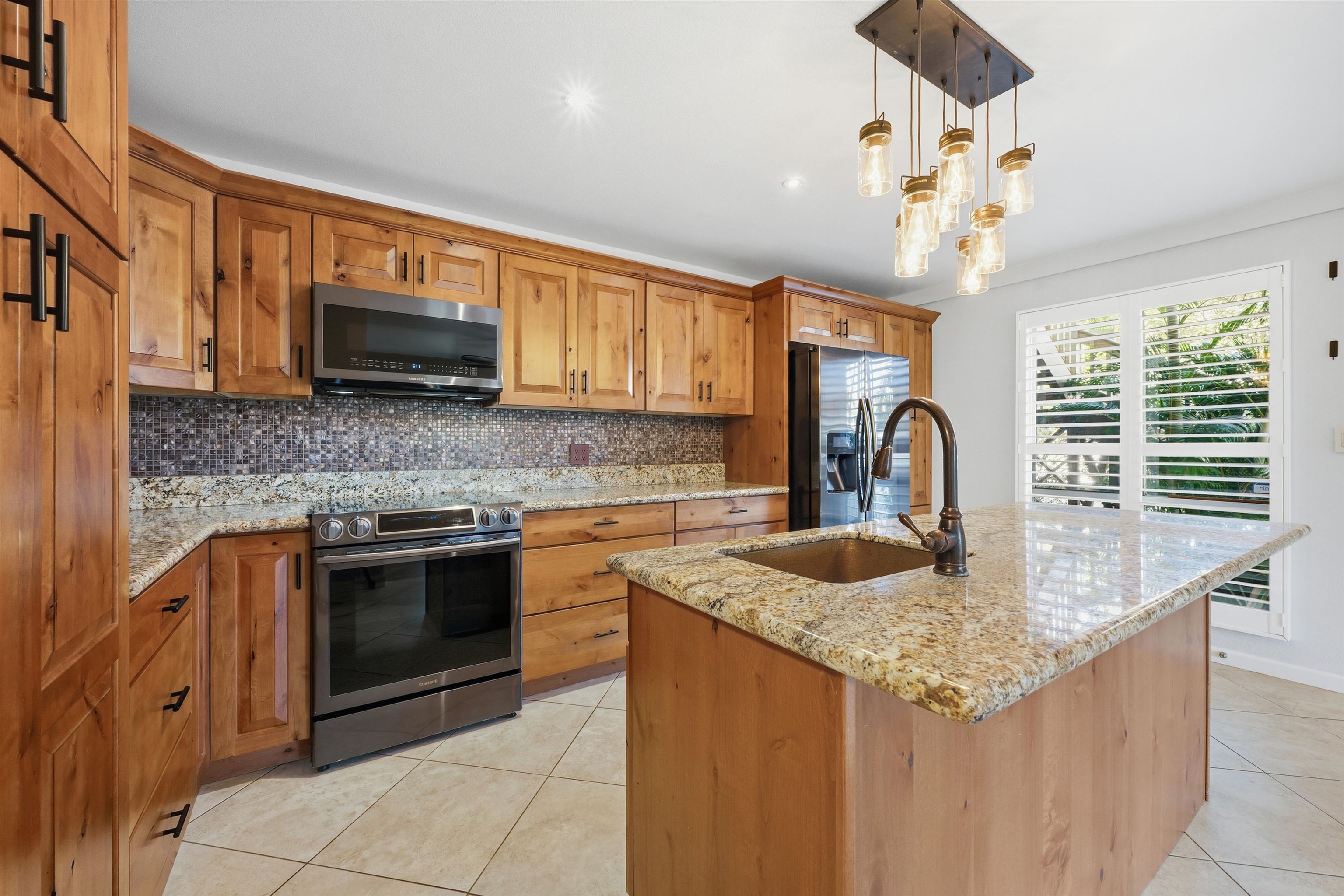 a kitchen with kitchen island granite countertop a sink and counter space