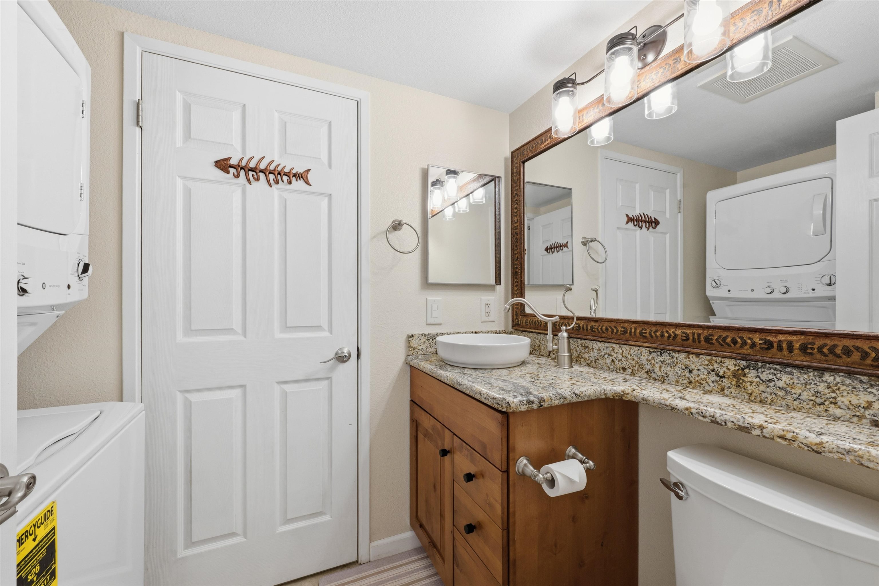 140 Uwapo Road, Unit 39101 Kihei, HI 96753 - Photo 17 of 35 a bathroom with a granite countertop sink and a mirror
