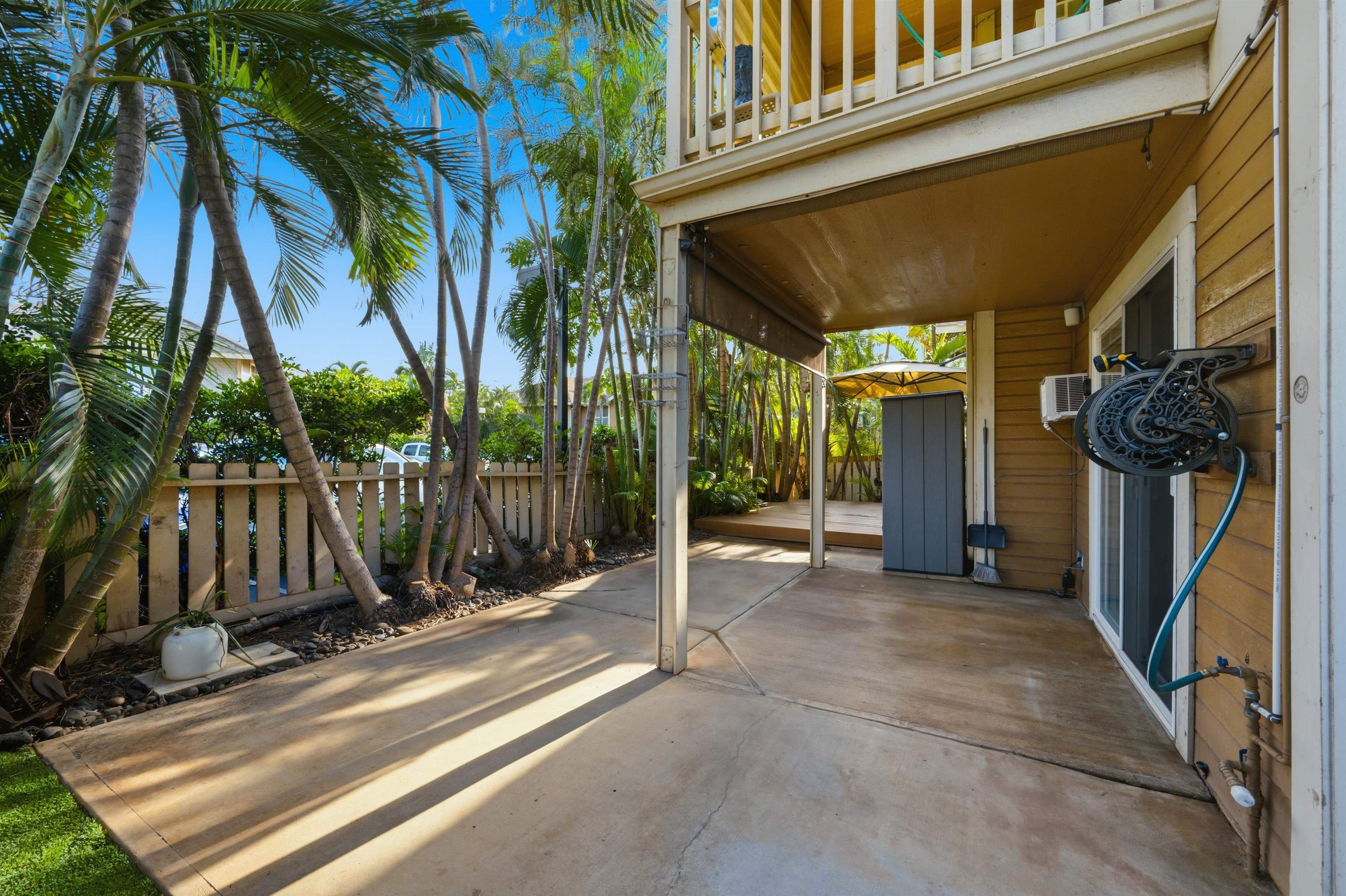 140 Uwapo Road, Unit 39101 Kihei, HI 96753 - Photo 25 of 35 a view of a house with a large window and wooden fence