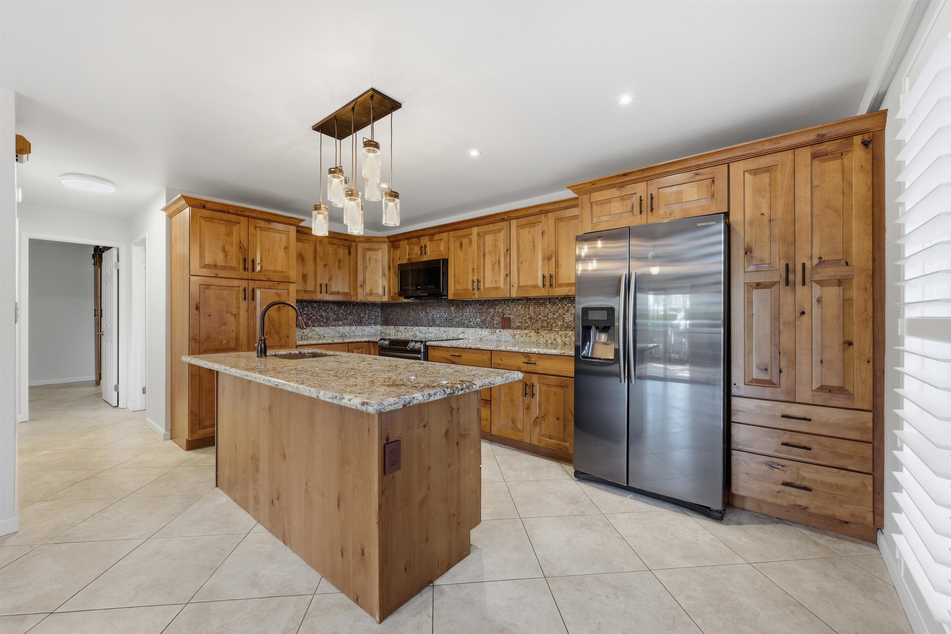 140 Uwapo Road, Unit 39101 Kihei, HI 96753 - Photo 10 of 35 a kitchen with stainless steel appliances granite countertop a refrigerator and a stove