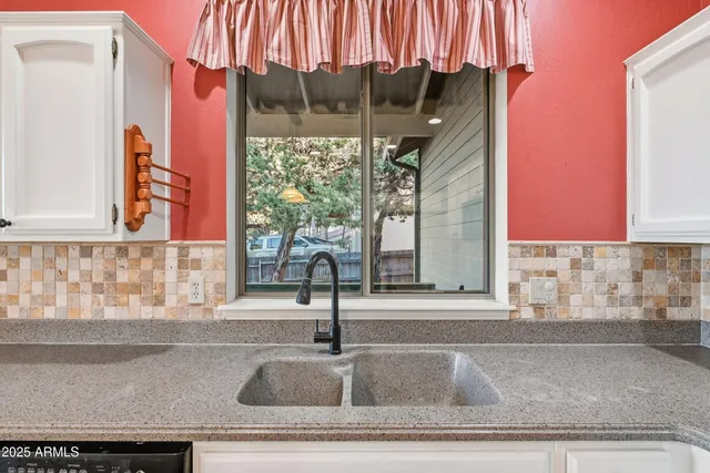 a kitchen with a stove a sink dishwasher and a refrigerator