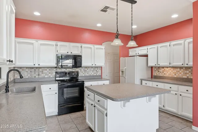 a view of a livingroom with wooden floor a fireplace and windows