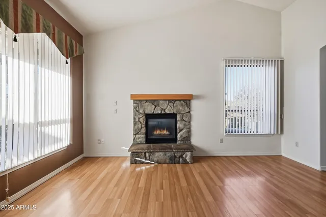 wooden floor in an empty room with a fireplace