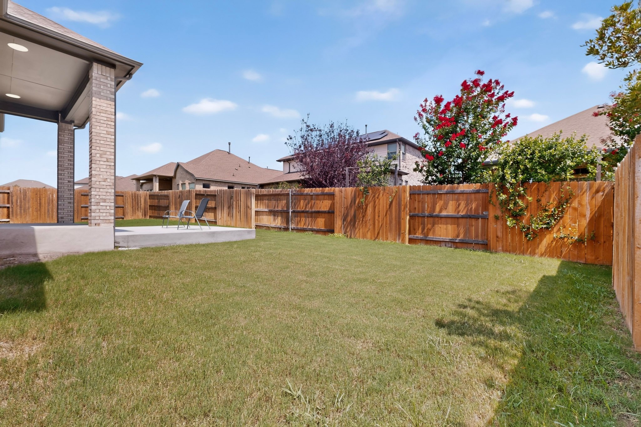 2433 La Mirada Street Leander, TX 78641 - Photo 25 of 25 A spacious backyard with a private fence, verdant lawn, and covered patio.