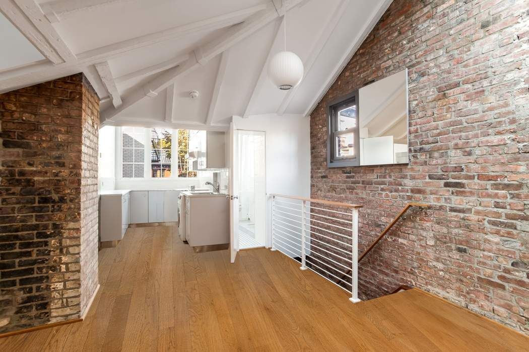 46 Commerce Street, Unit 5 Manhattan, NY 10014 - Photo 5 of 11 a view of a hallway with wooden floor and a large window