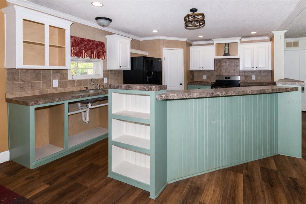 18057 Southwest 37th Street Dunnellon, FL 34432 - Photo 5 of 9 a kitchen with stainless steel appliances granite countertop a stove and a sink