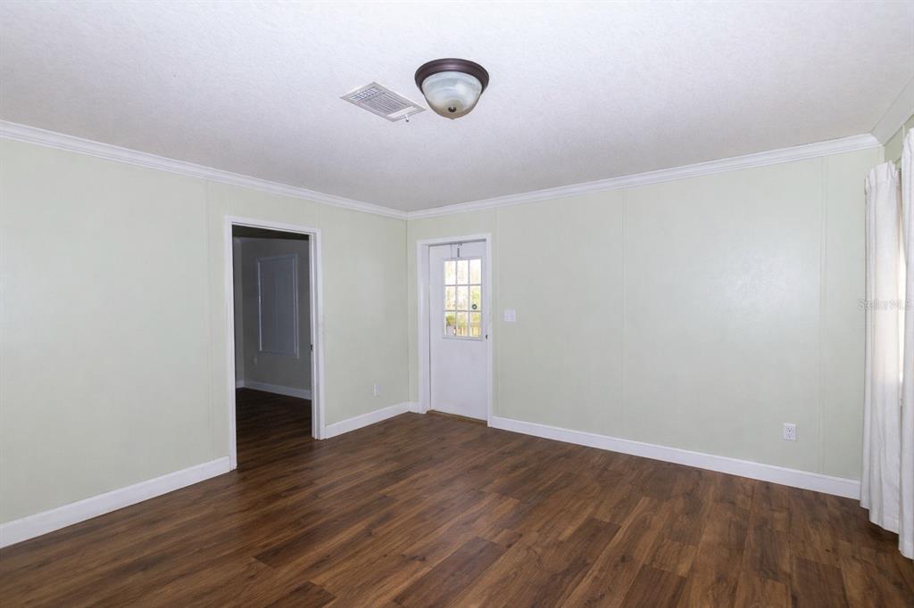 18057 Southwest 37th Street Dunnellon, FL 34432 - Photo 7 of 9 a view of an empty room with wooden floor and windows