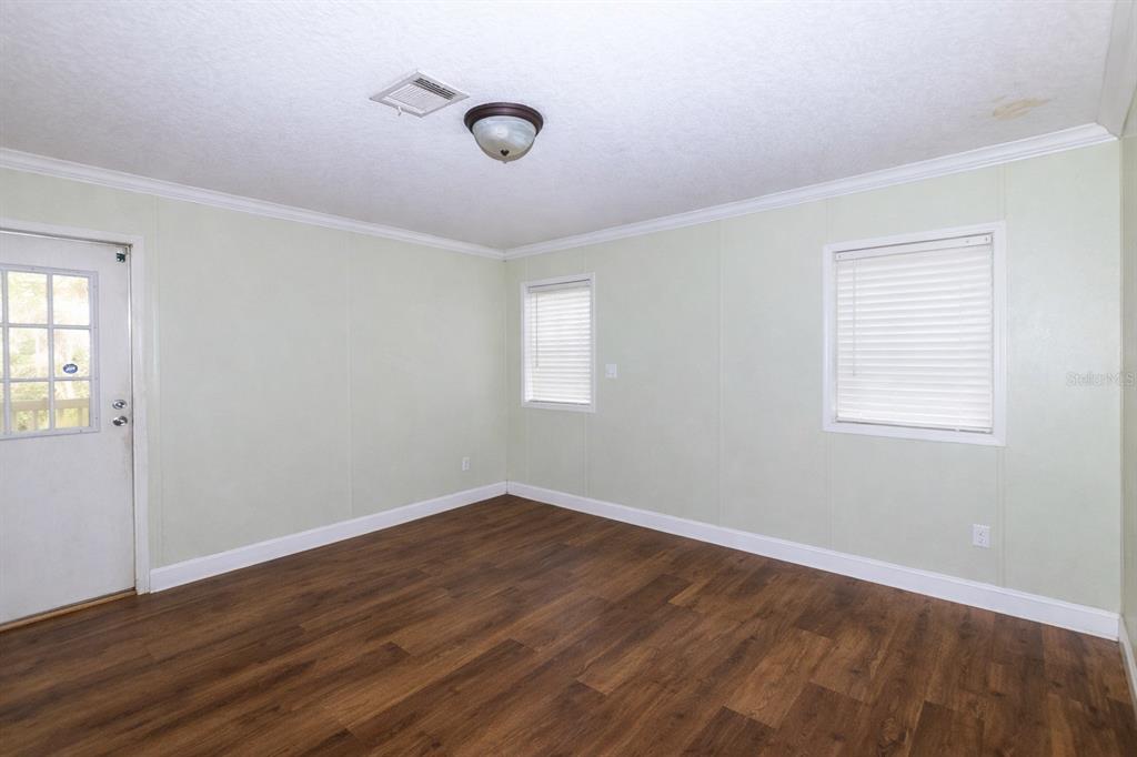 18057 Southwest 37th Street Dunnellon, FL 34432 - Photo 9 of 9 an empty room with wooden floor and windows