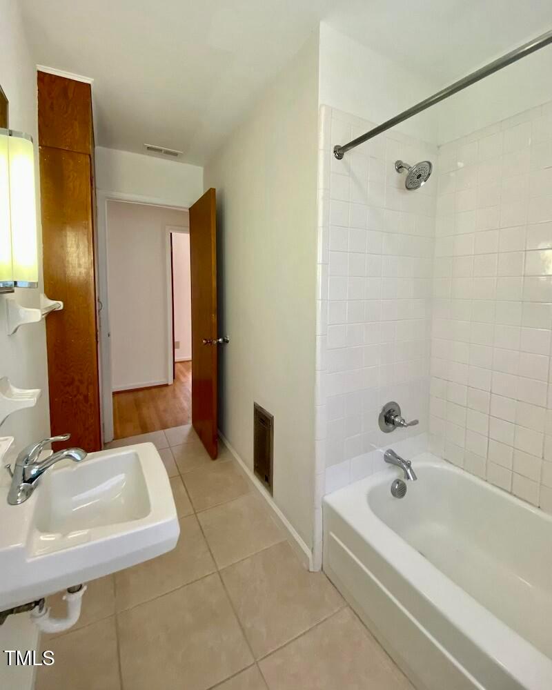 808 North Buchanan Boulevard, Unit B Durham, NC 27701 - Photo 15 of 23 a bathroom with a tub a sink and a mirror