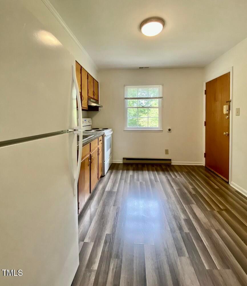 808 North Buchanan Boulevard, Unit B Durham, NC 27701 - Photo 8 of 23 wooden floor in an empty room with a window