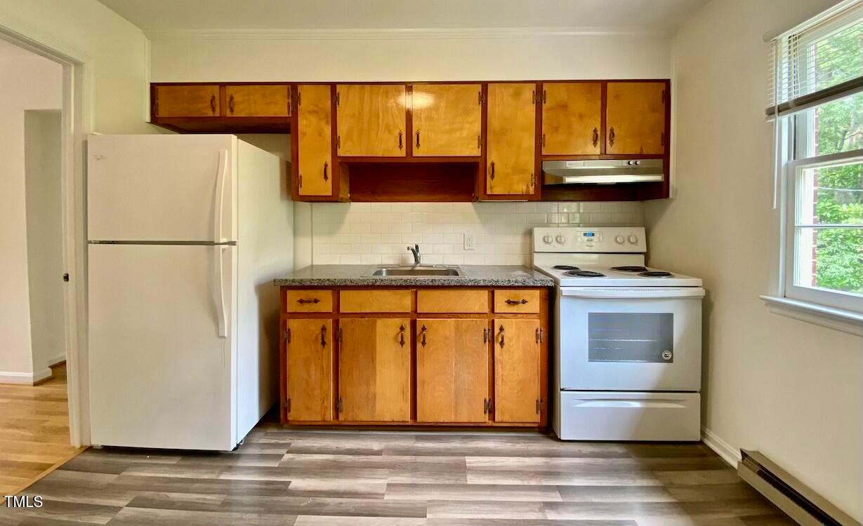 808 North Buchanan Boulevard, Unit B Durham, NC 27701 - Photo 9 of 23 a kitchen with a refrigerator and a sink