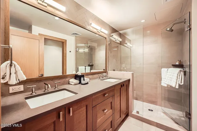 a bathroom with a sink double vanity and a mirror