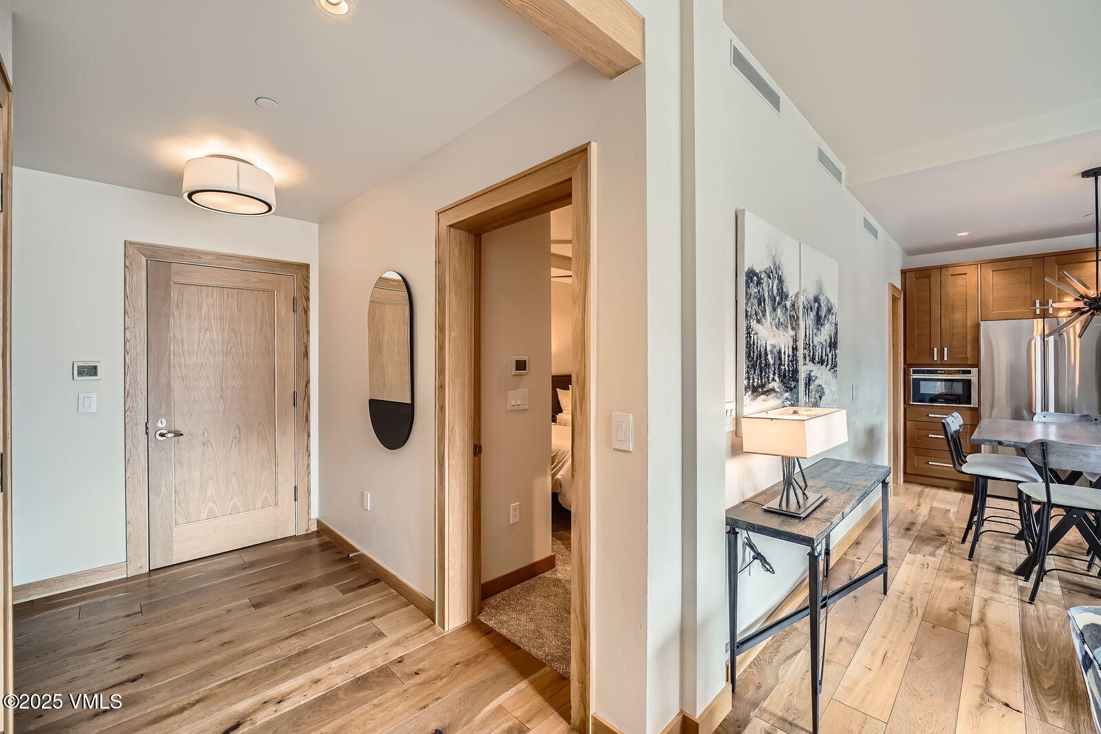 1 Waterfront Way, Unit 102 Avon, CO 81620 - Photo 5 of 22 a view of a hallway with wooden floor and dining room