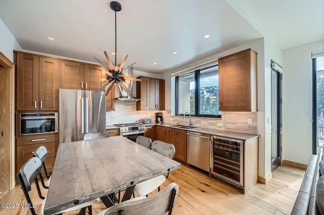 a kitchen with stainless steel appliances granite countertop a stove refrigerator and cabinets