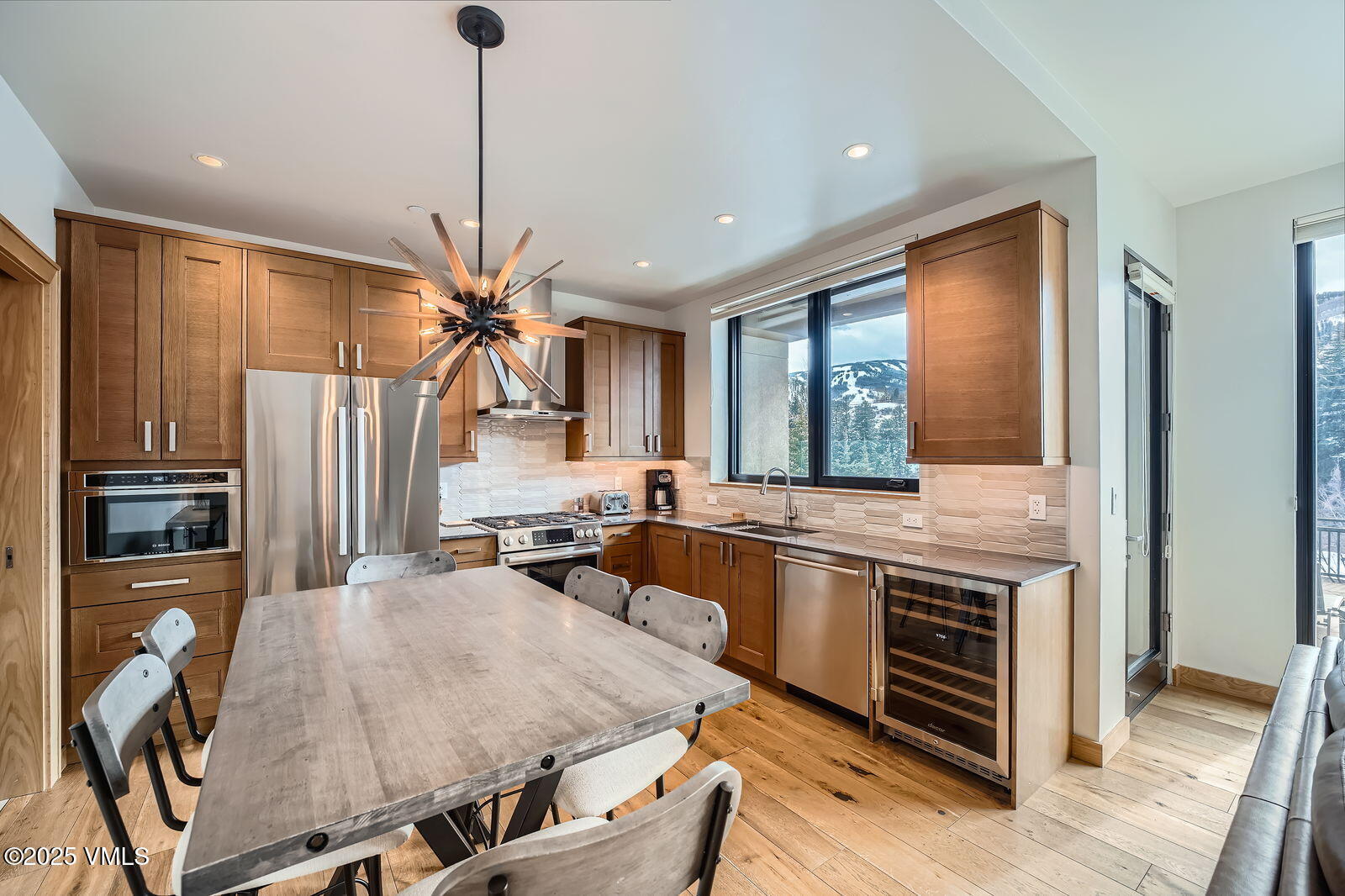 1 Waterfront Way, Unit 102 Avon, CO 81620 - Photo 7 of 22 a kitchen with stainless steel appliances granite countertop a stove refrigerator and cabinets