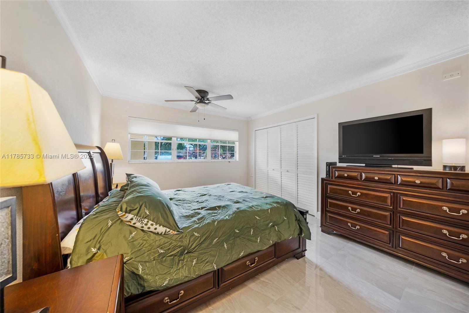 Palm Aire Pompano Beach, FL 33069 - Photo 12 of 27 a bedroom with a bed and a flat screen tv