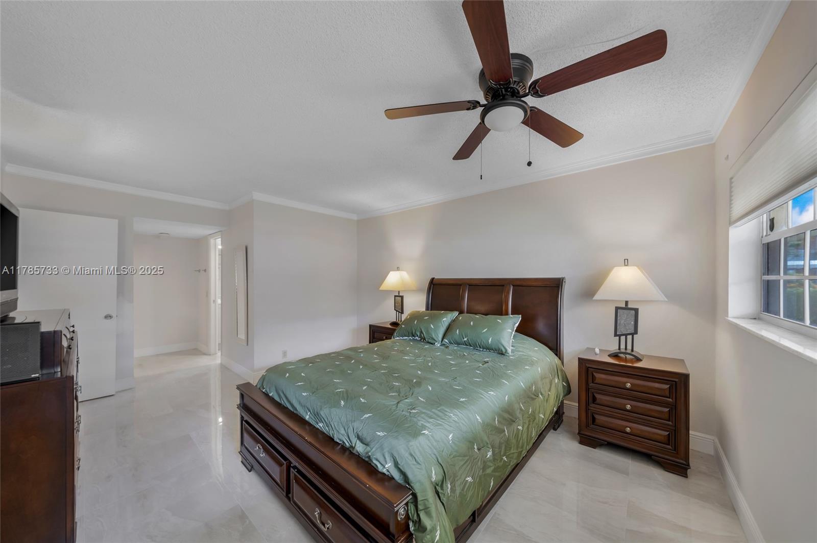 Palm Aire Pompano Beach, FL 33069 - Photo 13 of 27 a bedroom with a bed and a ceiling fan