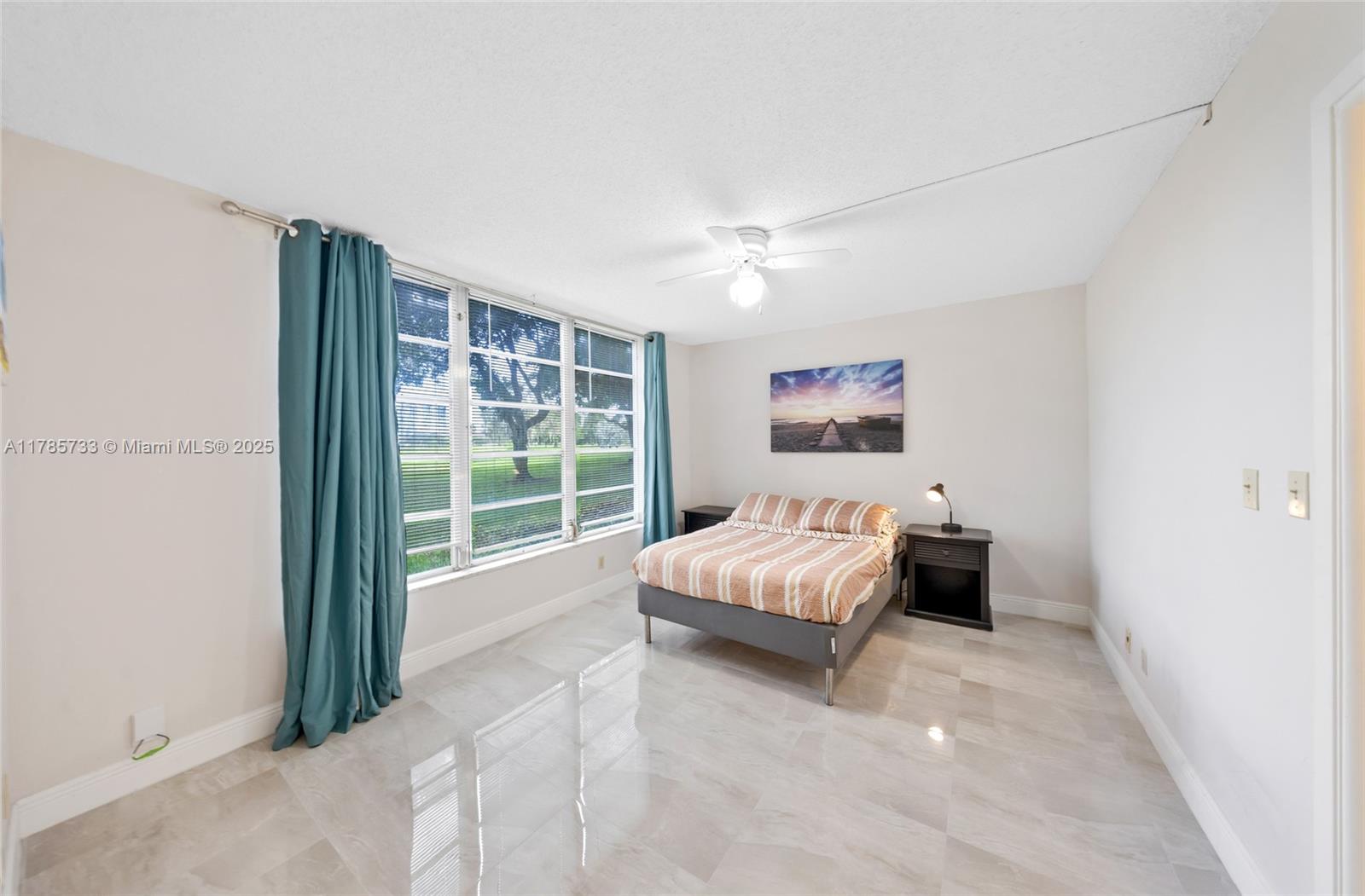 Palm Aire Pompano Beach, FL 33069 - Photo 17 of 27 a bed room with a bed and a window