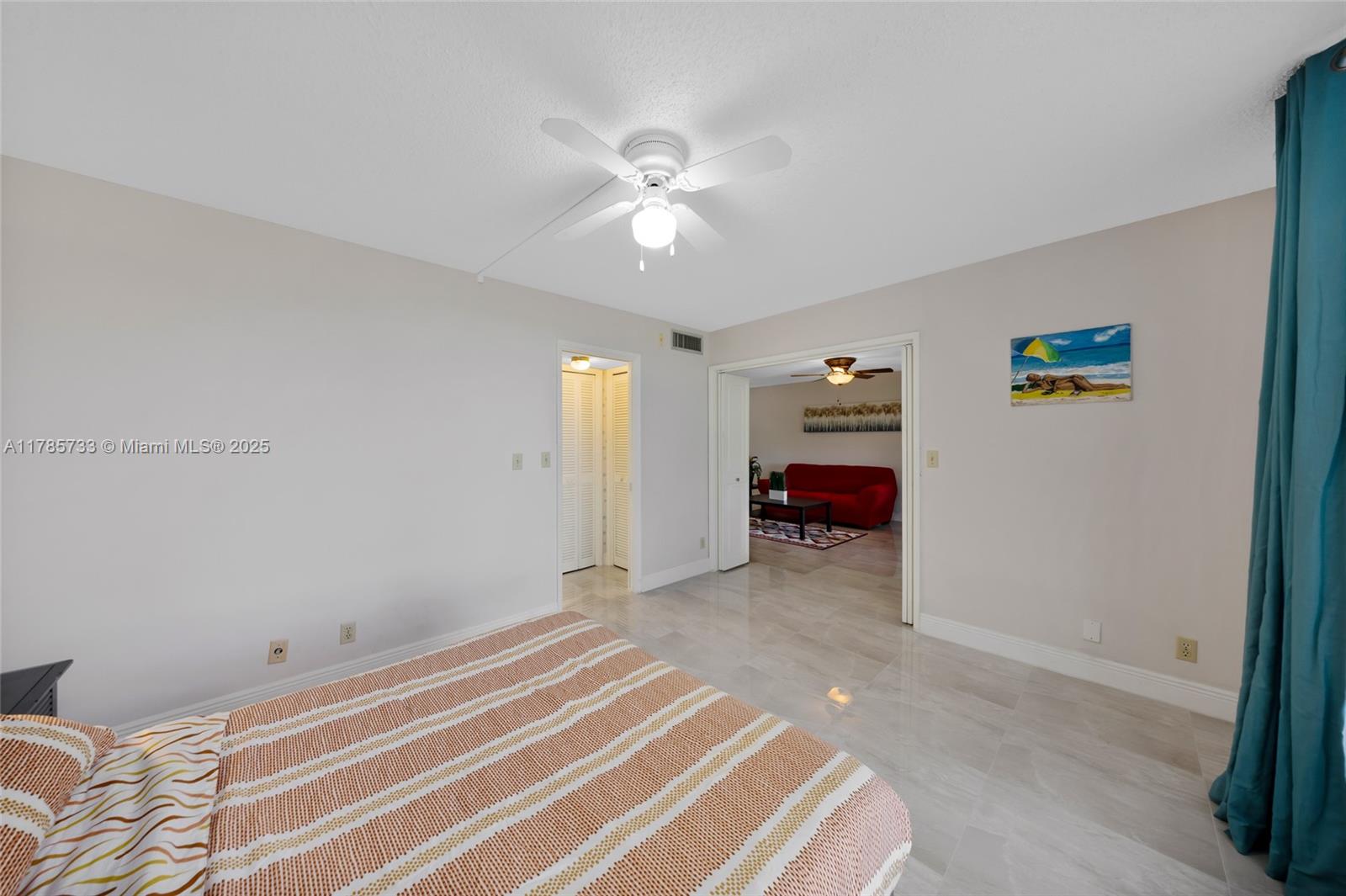 Palm Aire Pompano Beach, FL 33069 - Photo 19 of 27 a bedroom with a bed and a chandelier