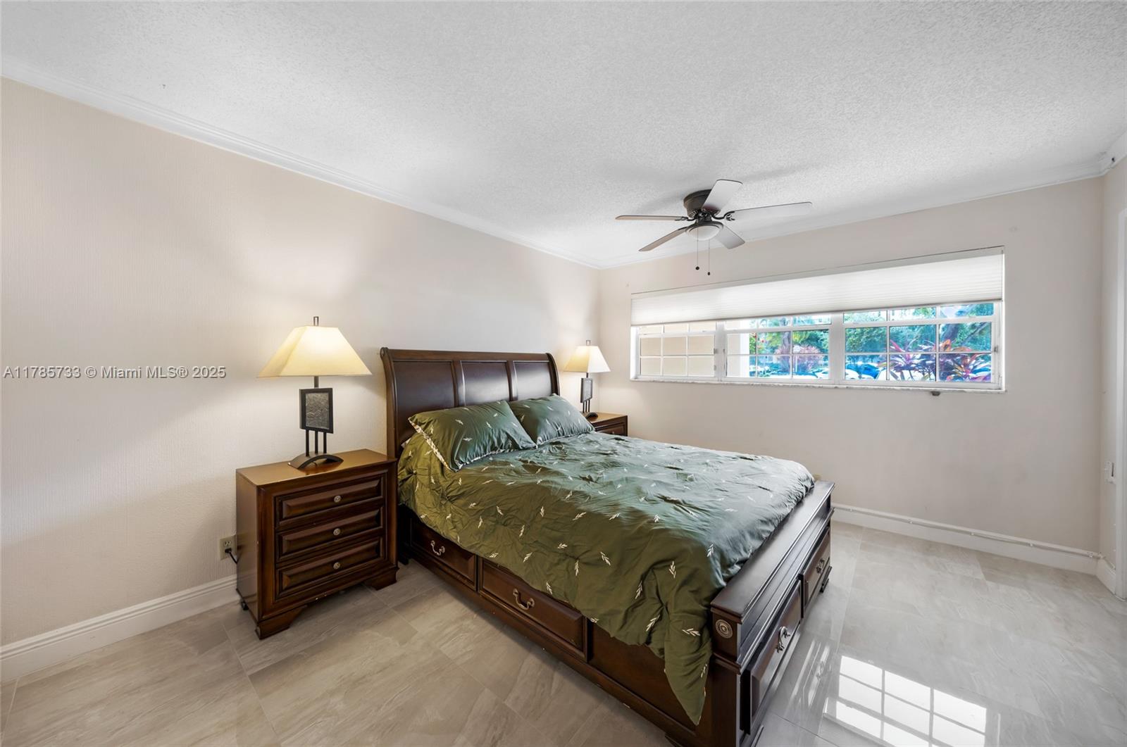 Palm Aire Pompano Beach, FL 33069 - Photo 27 of 27 a bedroom with a bed and a lamp on table