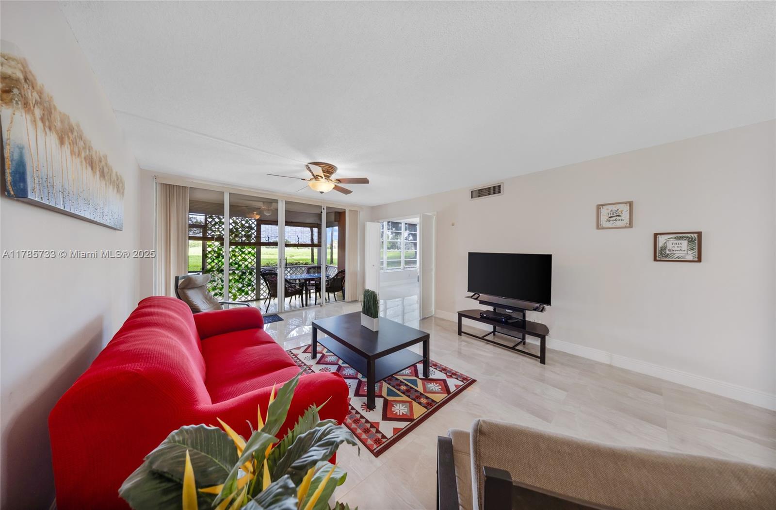 Palm Aire Pompano Beach, FL 33069 - Photo 7 of 27 a living room with furniture and a flat screen tv