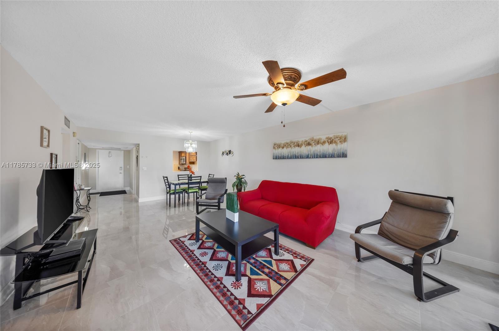 Palm Aire Pompano Beach, FL 33069 - Photo 10 of 27 a living room with furniture a flat screen tv and a window
