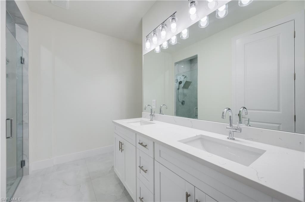 650 Kraft Street Lehigh Acres, FL 33974 - Photo 16 of 29 a bathroom with a sink and a mirror