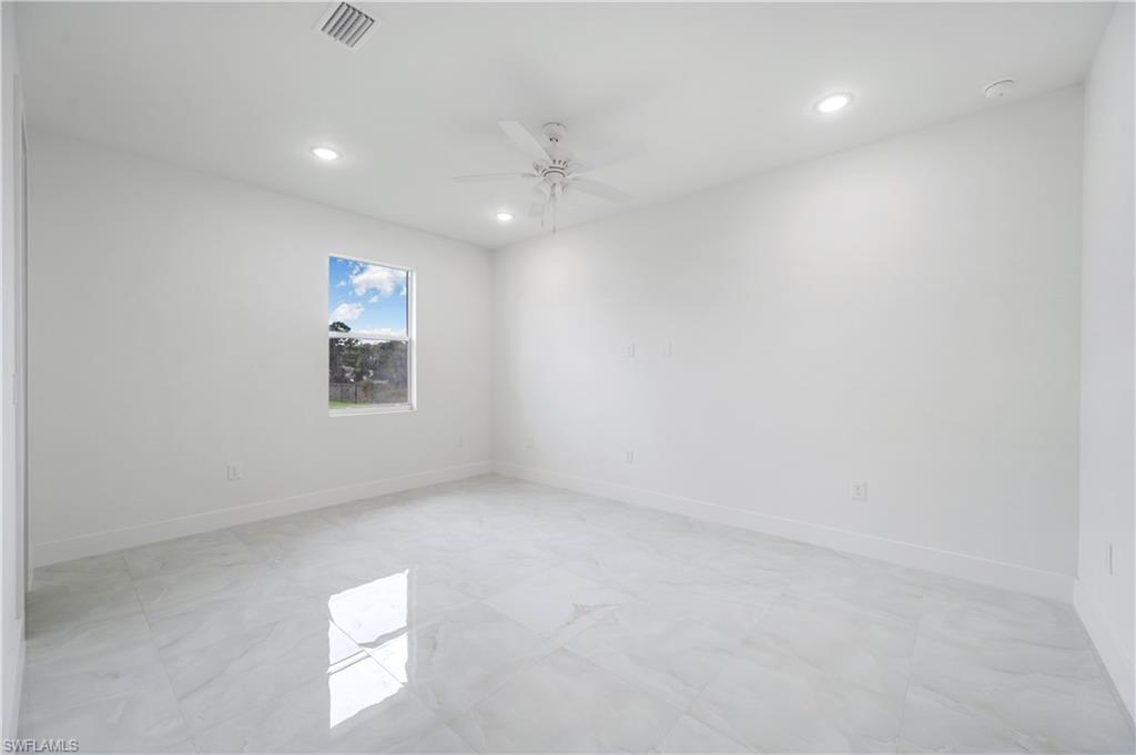 650 Kraft Street Lehigh Acres, FL 33974 - Photo 19 of 29 an empty room with a window and a fan
