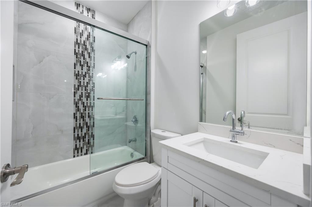 650 Kraft Street Lehigh Acres, FL 33974 - Photo 20 of 29 a bathroom with a sink toilet and shower