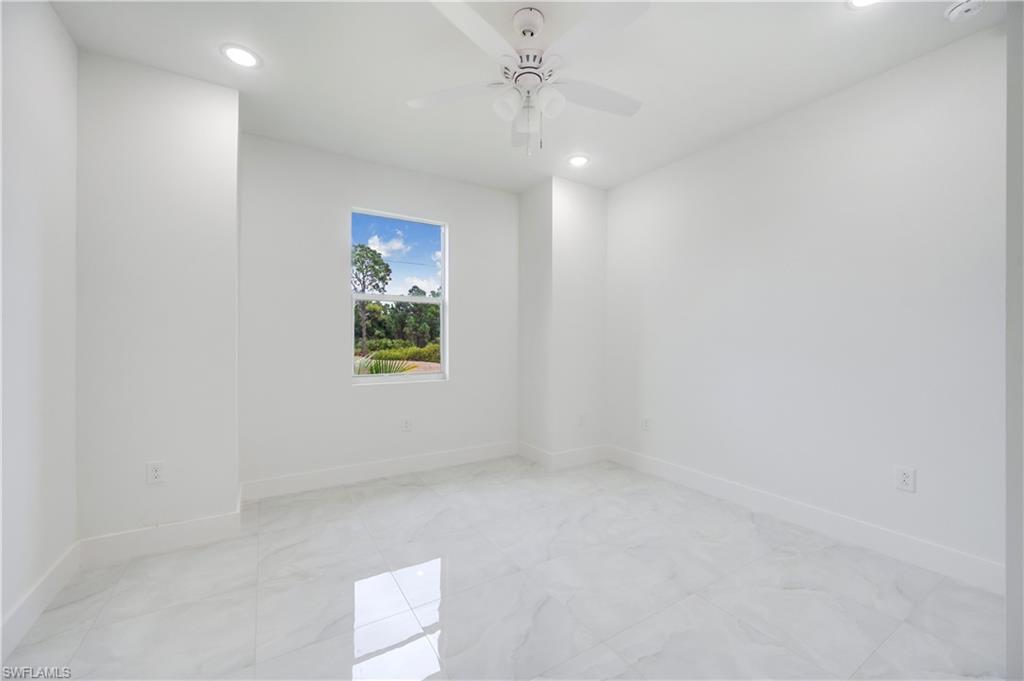 650 Kraft Street Lehigh Acres, FL 33974 - Photo 24 of 29 an empty room with a window and a ceiling fan