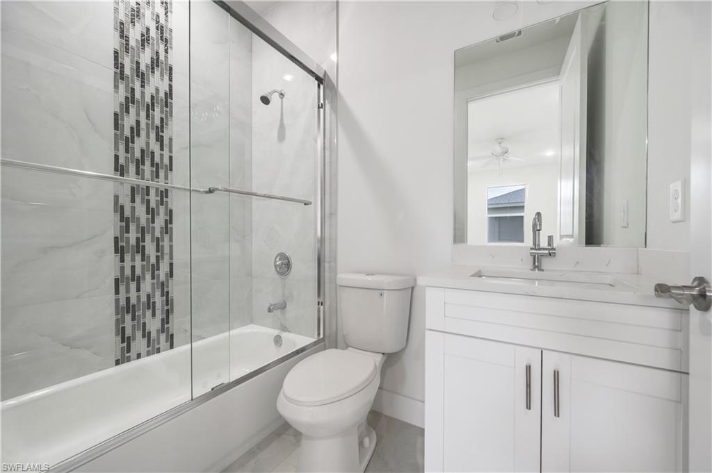 650 Kraft Street Lehigh Acres, FL 33974 - Photo 25 of 29 a bathroom with a sink a toilet and shower