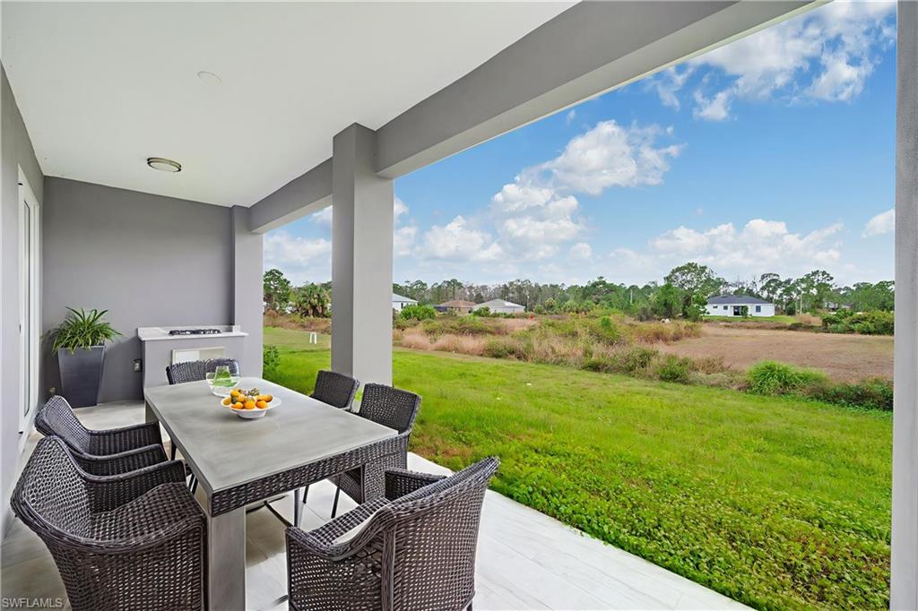 650 Kraft Street Lehigh Acres, FL 33974 - Photo 27 of 29 a view of a porch with furniture and a yard