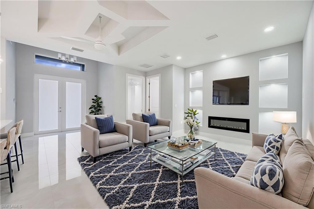 650 Kraft Street Lehigh Acres, FL 33974 - Photo 6 of 29 a living room with furniture a rug and a flat screen tv