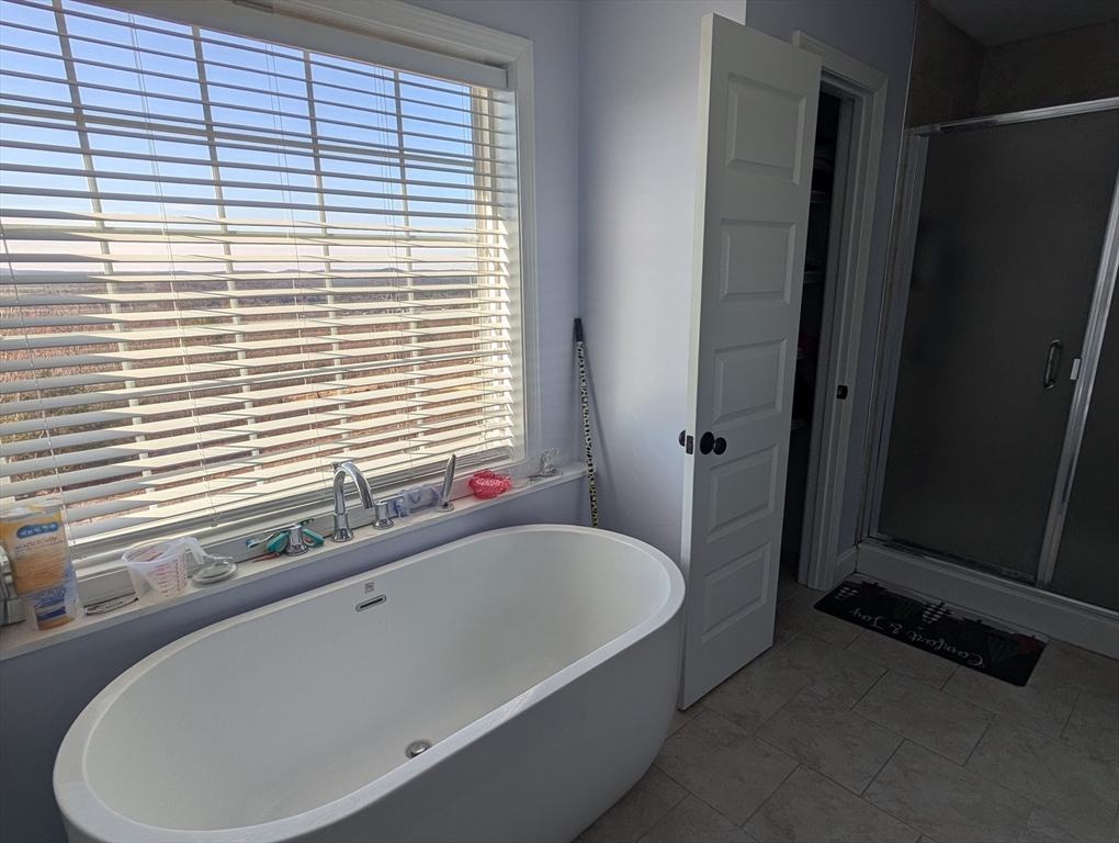 456 Ridge Road Athol, MA 01331 - Photo 17 of 26 a bathroom with a bathtub and next to a window