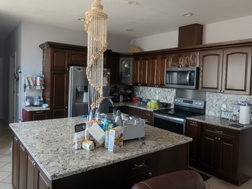 456 Ridge Road Athol, MA 01331 - Photo 10 of 26 a kitchen with granite countertop kitchen island stainless steel appliances a sink refrigerator and microwave