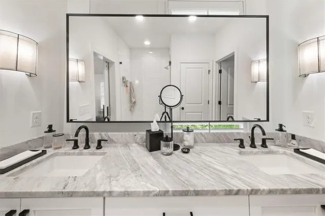 a bathroom with a double vanity sink and a mirror