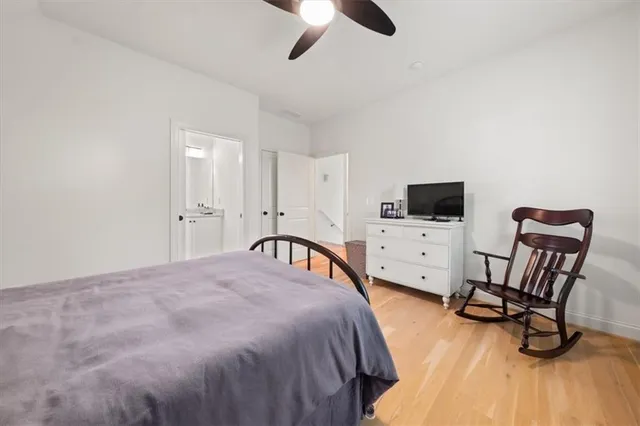 a bedroom with furniture and a flat screen tv
