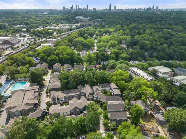 an aerial view of residential house with outdoor space and trees all around
