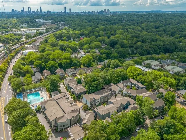 an aerial view of a house with a yard and a lot of flower plants