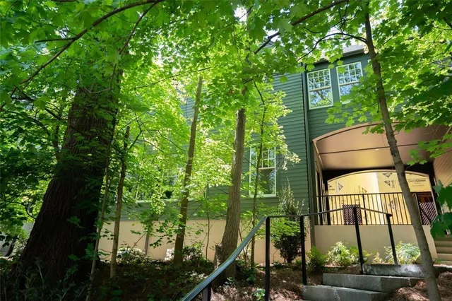 a view of a patio with table and chairs and potted plants