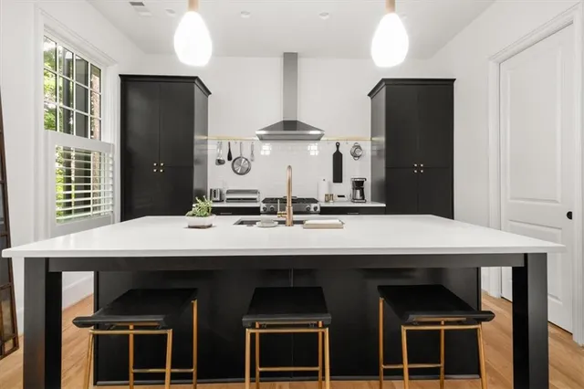 a kitchen with a sink stainless steel appliances and cabinets
